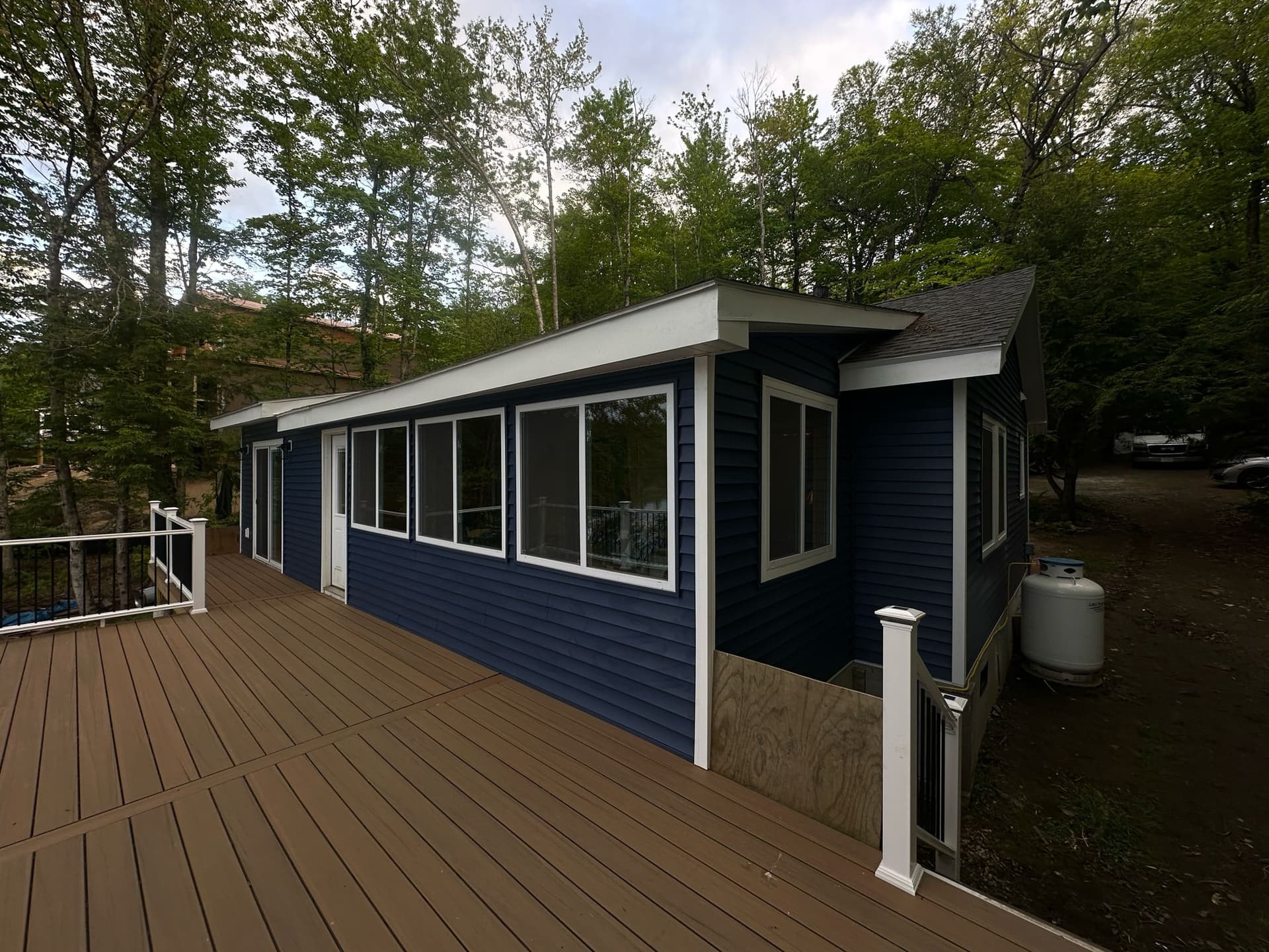 Vinyl siding installation deck and side view on lakefront cottage, MA