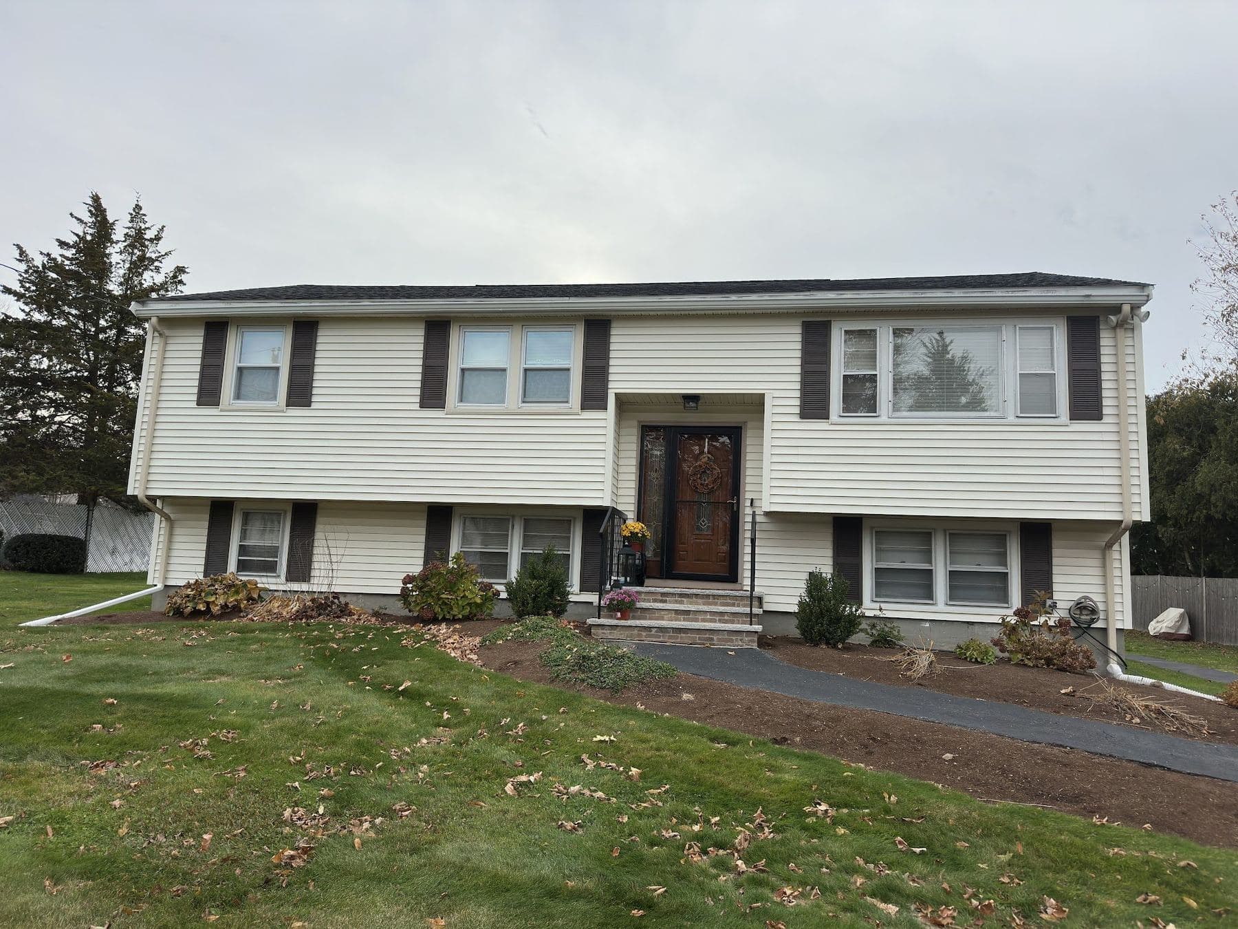 Cream raised ranch with black shutters in Stoughton, MA