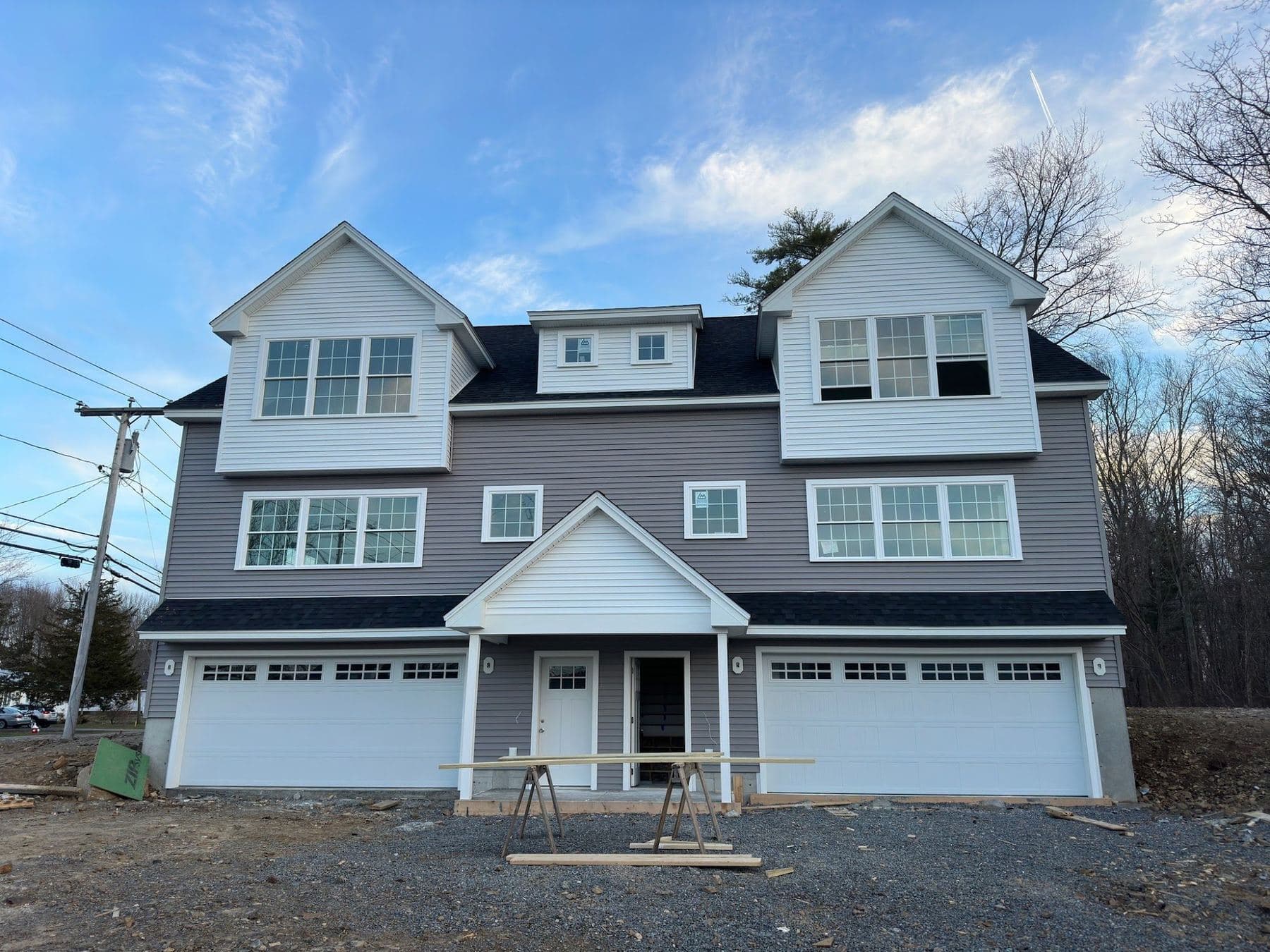 Gray two-family home with white dormers in Seabrook, NH