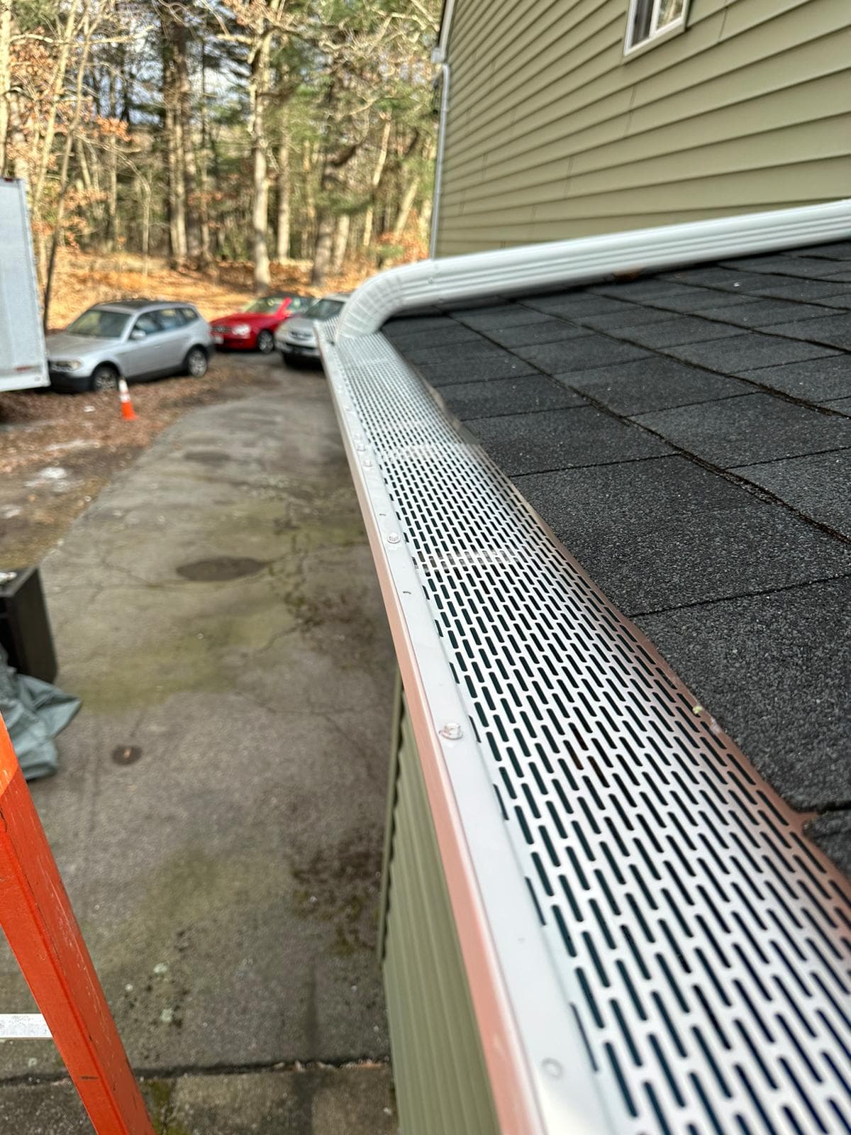 Seamless gutter with leaf guard on residential home, MA