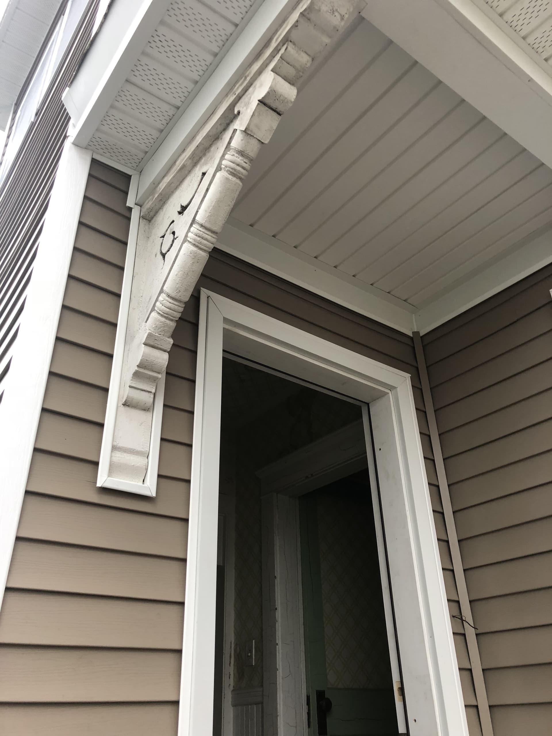 Custom door trim and corbel detail by Wolf's Siding, MA